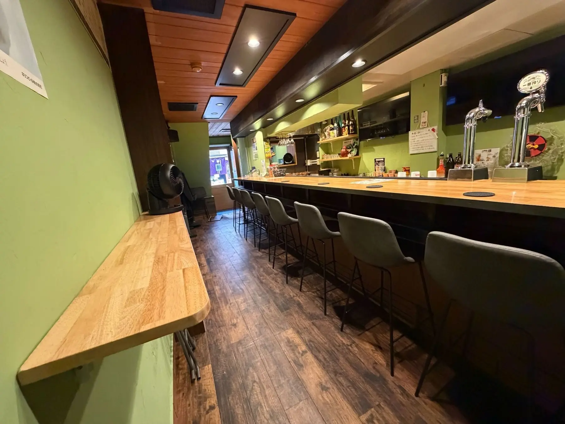 Green walls and a pale wood counter